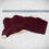 Thumbnail: Burgundy vegetable tanned leather hide next to a ruler for measurement