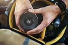 closeup-hands-getting-camera-lens-from-bag copie.webp