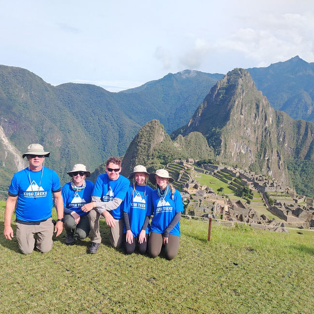 Group of hikers celebrating at Machu Picchu after completing the Inca Trail in Peru