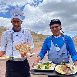 Kusa Treks chefs presenting traditional dishes during an Andean picnic on the Humantay Lake hike in Cusco, Peru