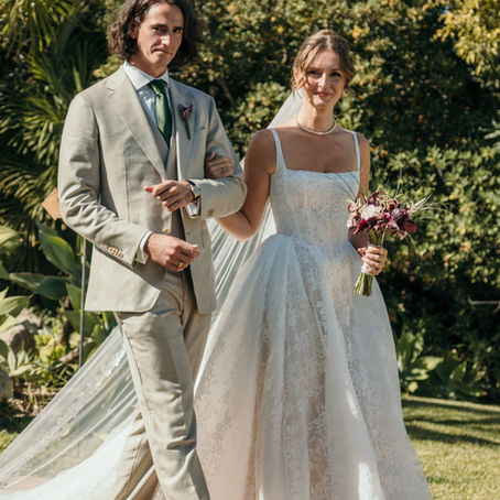 Bride and groom walking together during a destination wedding on the Costa del Sol, Spain, captured in natural Mediterranean light