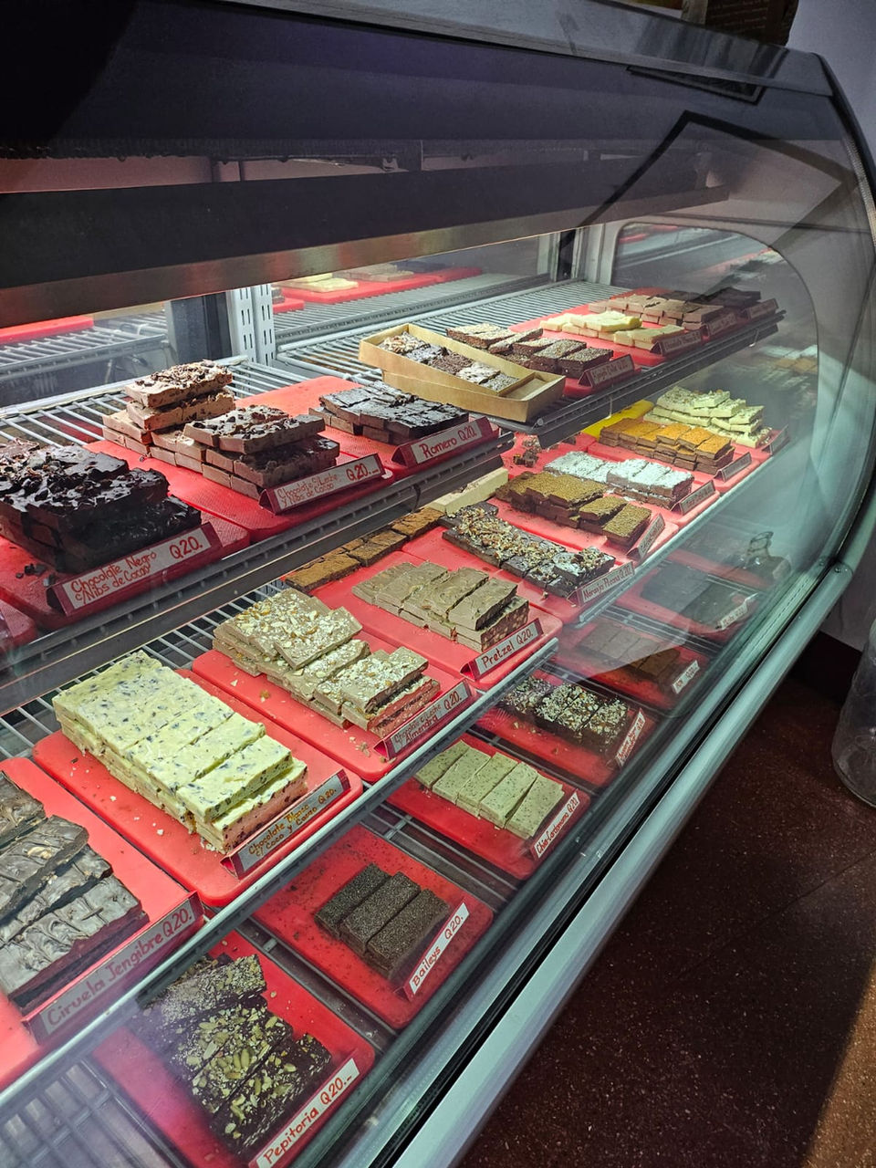 Display case with a variety of traditional Guatemalan sweets exhibited as part of the local popular food