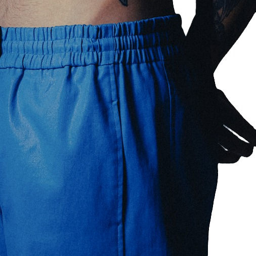 Thumbnail: waist detail, smurf blue, waxed denim drawstring pants with monochromatic stripe down full length of leg and extended tab.