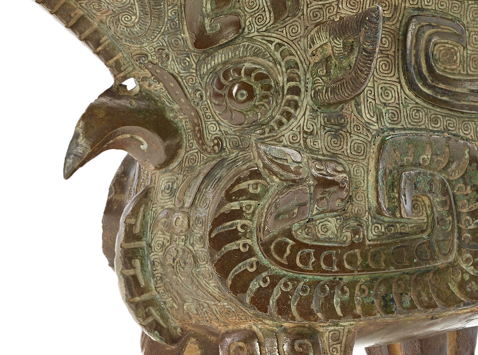 弗利爾美術館:商代青銅方觥 Close-up of an ornate bronze sculpture with intricate spiral patterns and smooth ancient designs, featuring earthy brown and green tones.