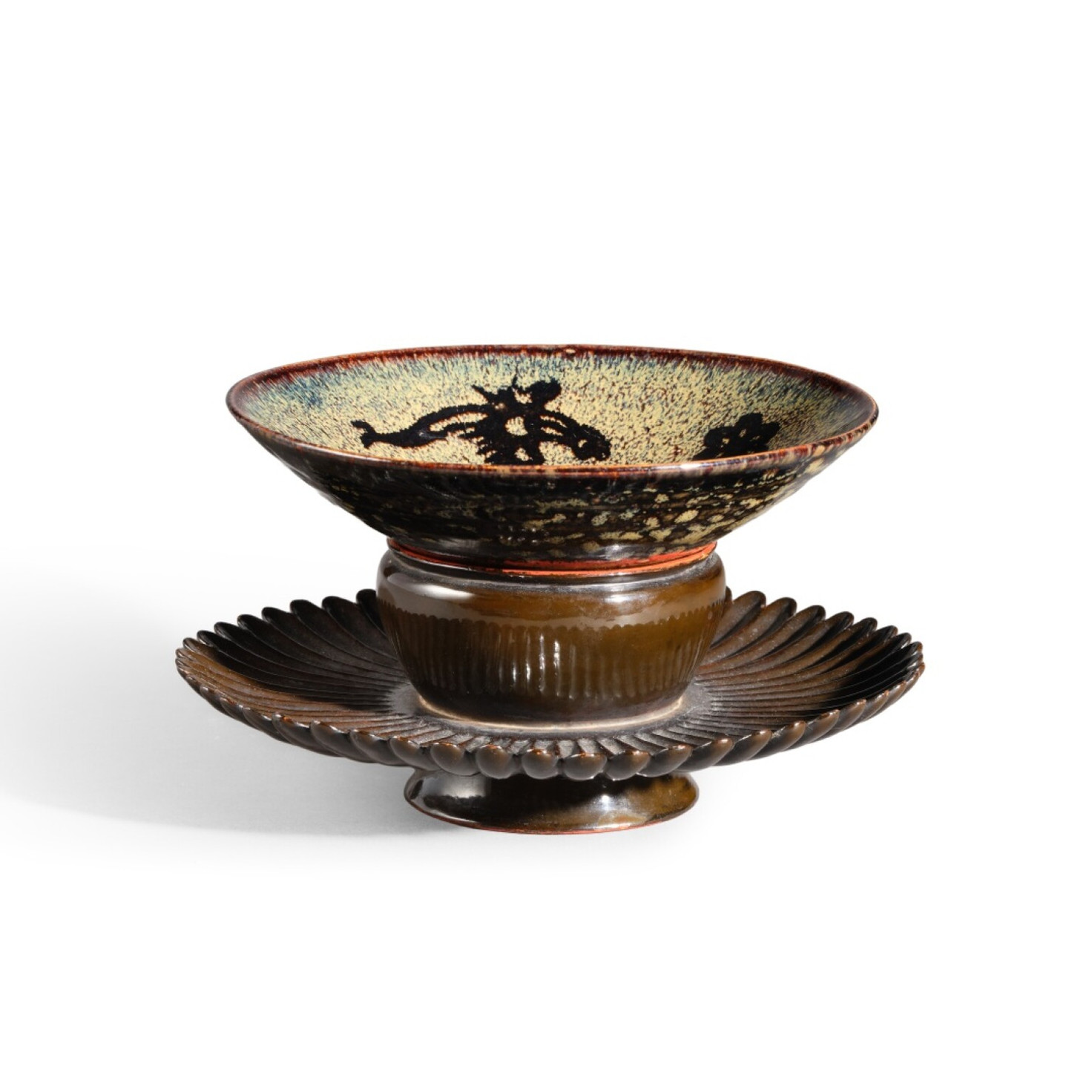 Brown ceramic bowl on a pedestal plate with black decorative pattern, isolated on a white background.