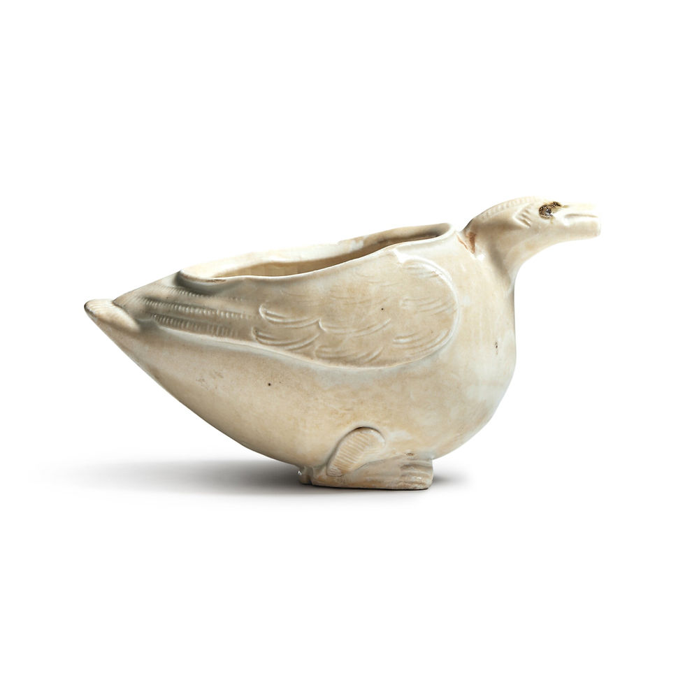 Cream ceramic vessel shaped like a bird, with engraved feather details, against a white background. Appears vintage and artistic.