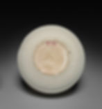 White ceramic bowl base with the number 57.51 in red, set against a dark gray background. Simple and understated.