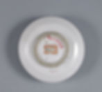 White ceramic plate bottom with red and black text on labels, set against a gray background. Visible numbers include 5886, 5518, and 4163.