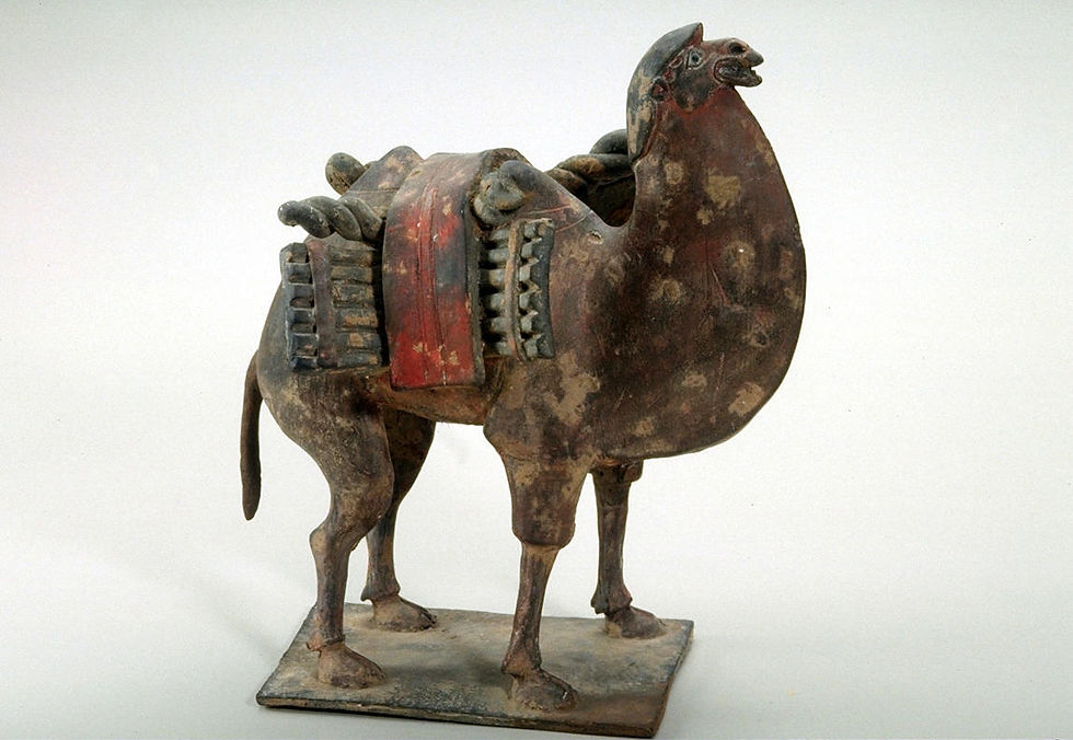 Ancient weathered horse sculpture with saddle details, standing on a base against a plain white background.