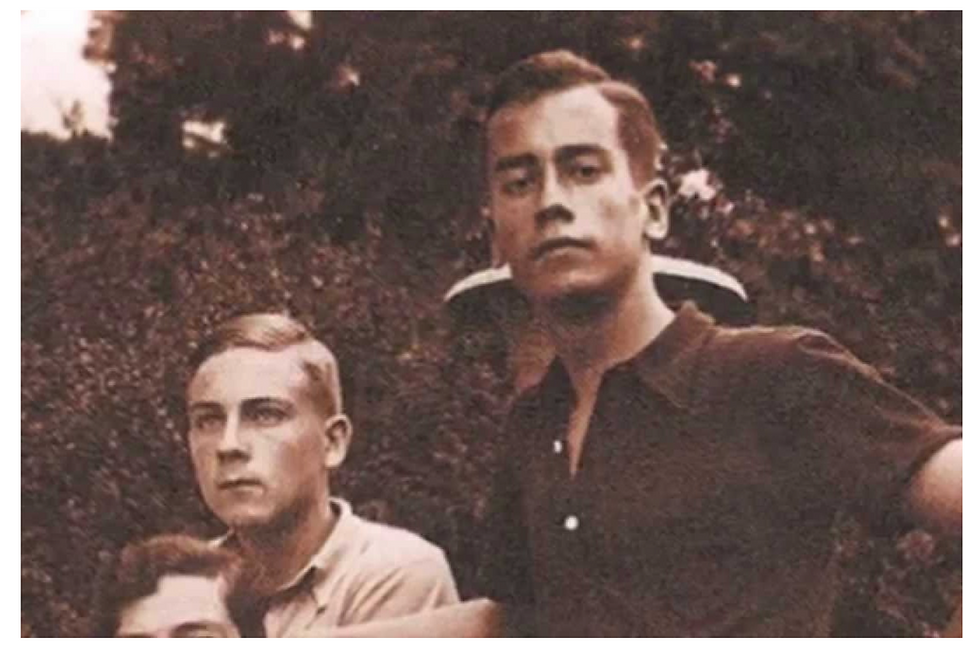 The Zuellig brothers - Gilbert (left) and Stephen (right) Two young men in vintage attire pose outdoors against a leafy background, displaying serious expressions. The image has a sepia tone.