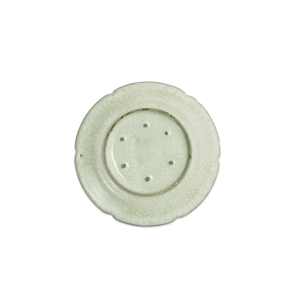 Antique white ceramic dish with a crackled glaze and six holes in the center, displayed on a plain white background.