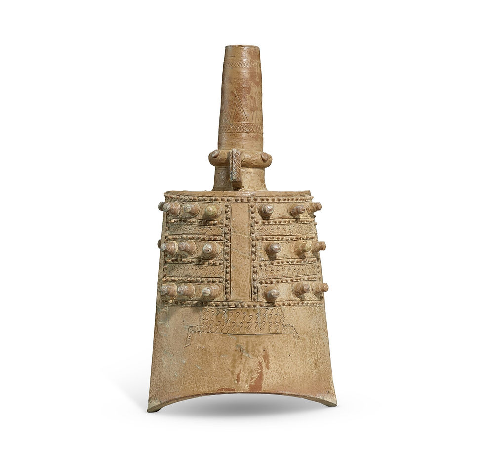 拍賣筆記 vol.302 蘇富比伊勢彥信專場:76.2萬港元成交,東周越窯早期青瓷甬鐘 - Sotheby’s Ise Sale, An Early Yue Kiln Green Glaze Bell, Yongzhong, Eastern Zhou Dynasty, Sold for 762,000 HKD / Ornate bronze bell with circular decorations, detailed engravings, and a textured surface. Neutral background emphasizes its historical design.