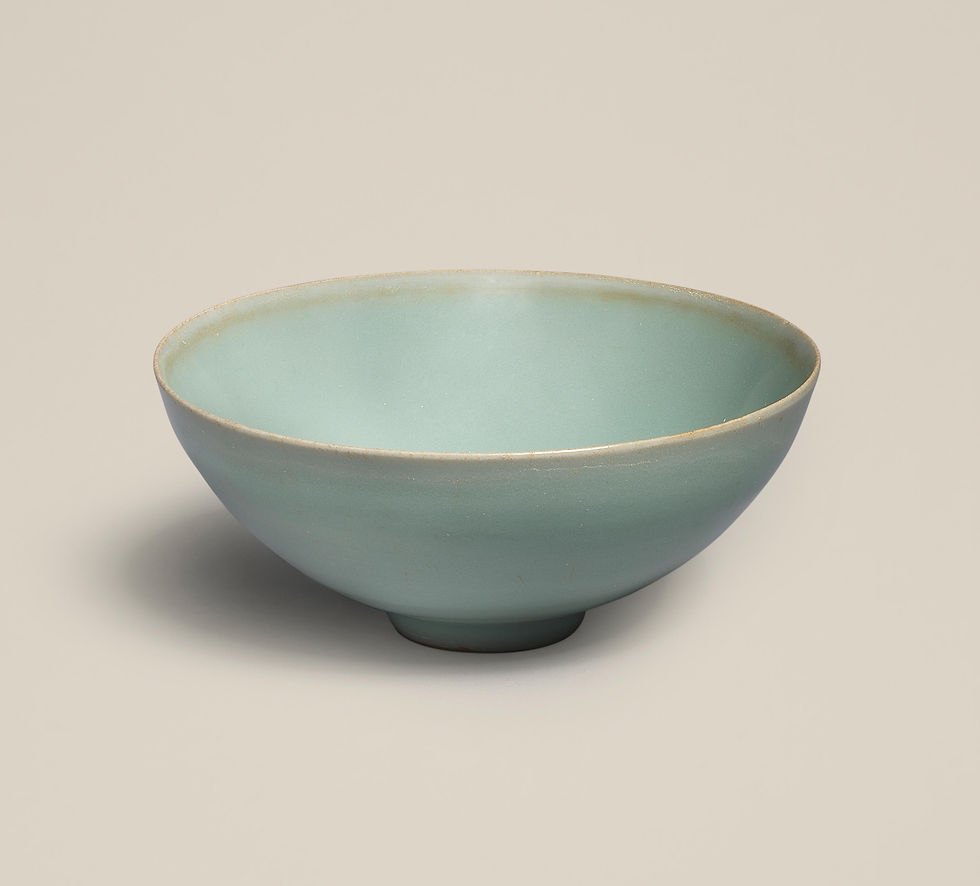 A pale green ceramic bowl on a light beige background. The bowl has a smooth texture and gentle gradient, giving a serene and minimalist feel.