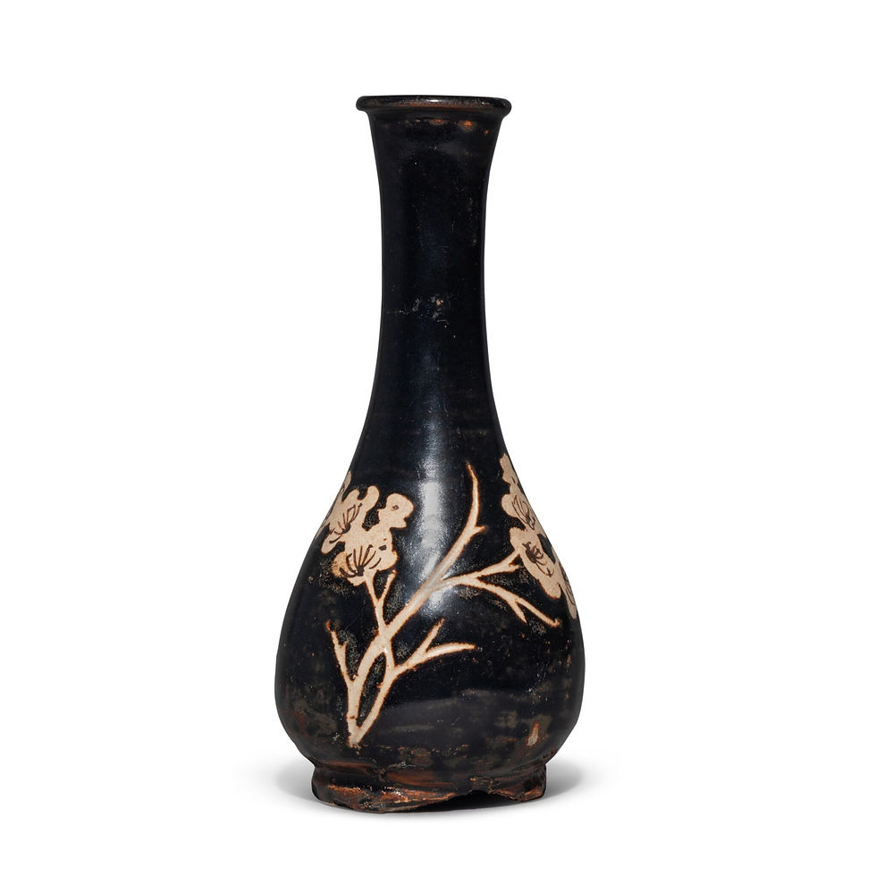 Black ceramic vase with tan floral branches on a white background, photographed like a museum object, no text visible