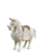 A weathered, ancient ceramic horse figurine with a rough texture, standing against a plain white background. Shades of white and brown.