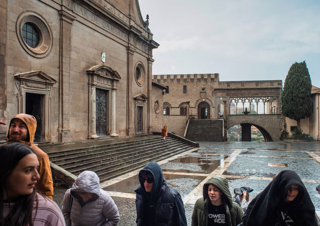 A group of young people in a medieval square in Italy. Image (c) Leonardo Di Lorenzo.