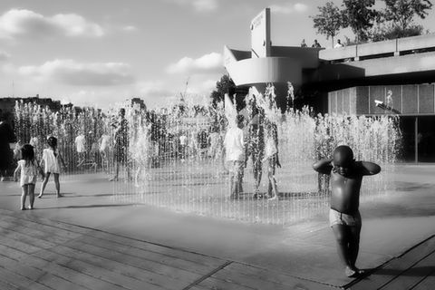 Children play in a fountain, enjoying summer fun in a public space. Image (c) Lenny Di Lorenzo.