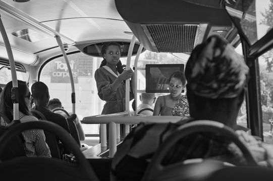 Elegantly dressed young black women on a London bus.  Image (c) Lenny Di Lorenzo.