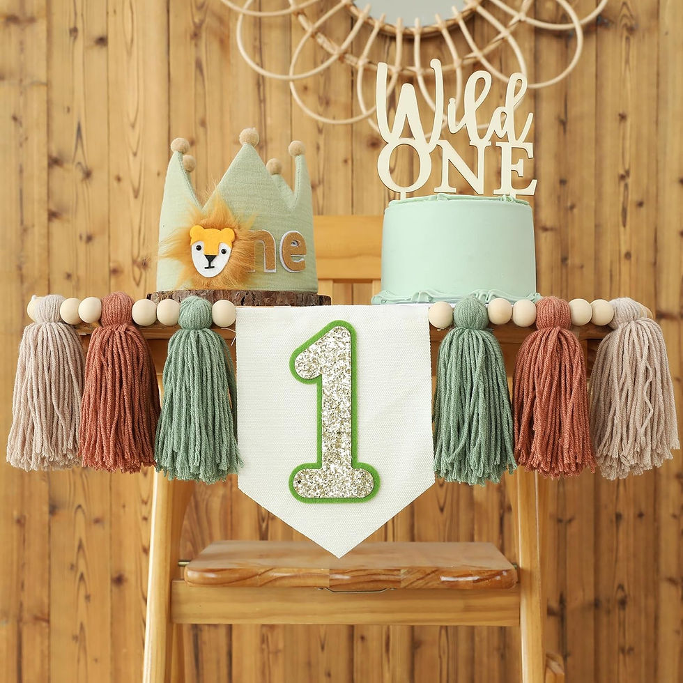 One-year birthday cake display with lion crown and Wild One topper, mint and tan tassels, rustic wood backdrop