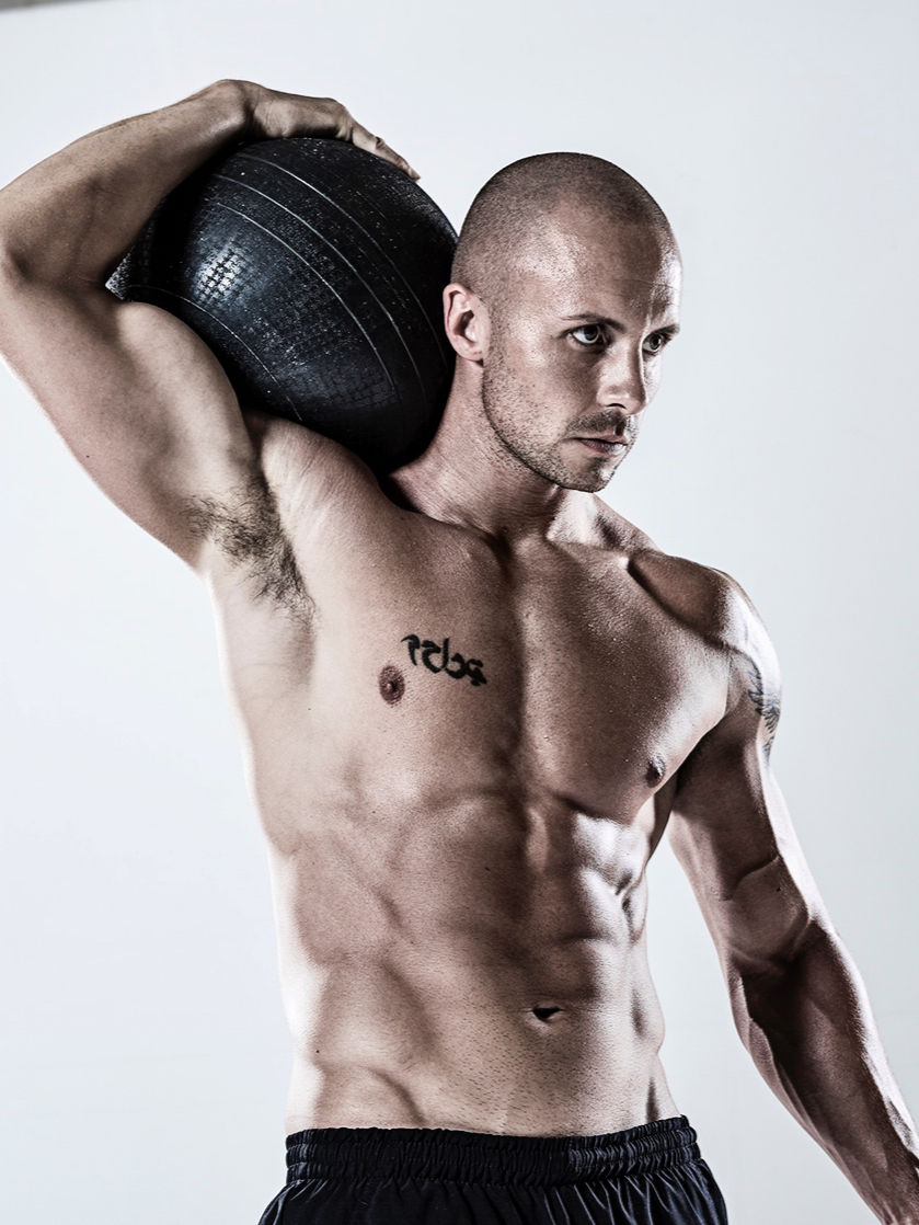 Man holding a medicine ball.