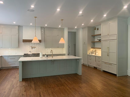 front view of grey kitchen renovation with floor to ceiling cabinetry and kitchen island with built in sink