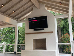 Deck remodel project with TV above fireplace