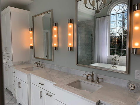 grey bathroom renovation project with double sinks and marble countertops
