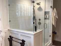 bathroom renovation with large white shower and glass surround