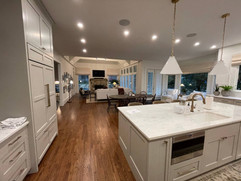 kitchen remodeling project with custom island with built in sink and microwave