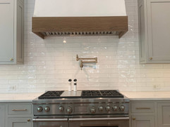 front view of kitchen remodel with stove and range hood