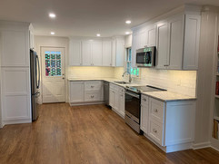 front view of kitchen remodel with custom cabinetry built around fridge