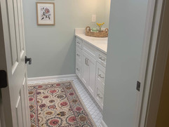 entrance view of renovated bathroom with tiled floor