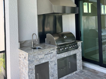 mosaic grill station with stainless backsplash custom outdoor kitchen stone finish Naples FL