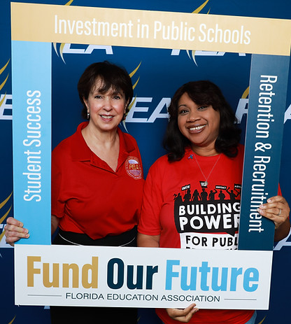 Island Coast FEA members holding sing "Fund Our Future"