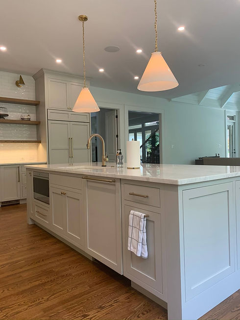 kitchen renovation project with large grey kitchen island with built in sink and microwave