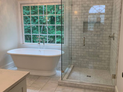 bathroom renovation project with bathtub and glass shower