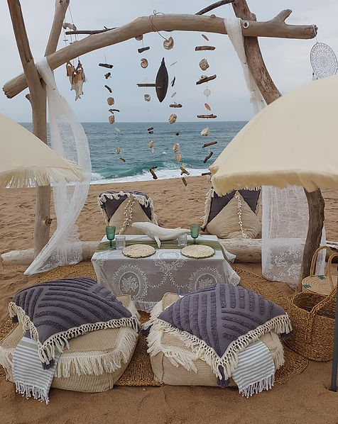 An image of a rustic outdoor setup, possibly a picnic, featuring wooden elements, decorations, and seating arrangements