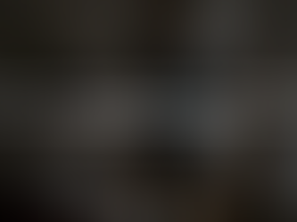 Woman adjusting custom drapery in sunlit living room