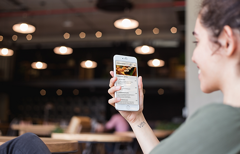 silver-iphone-8-mockup-featuring-a-happy-woman-with-a-wrist-tattoo-at-a-restaurant-a21267.