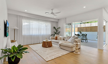 Living rom with couch, rug, plants and coffee table in a Lennox Head home
