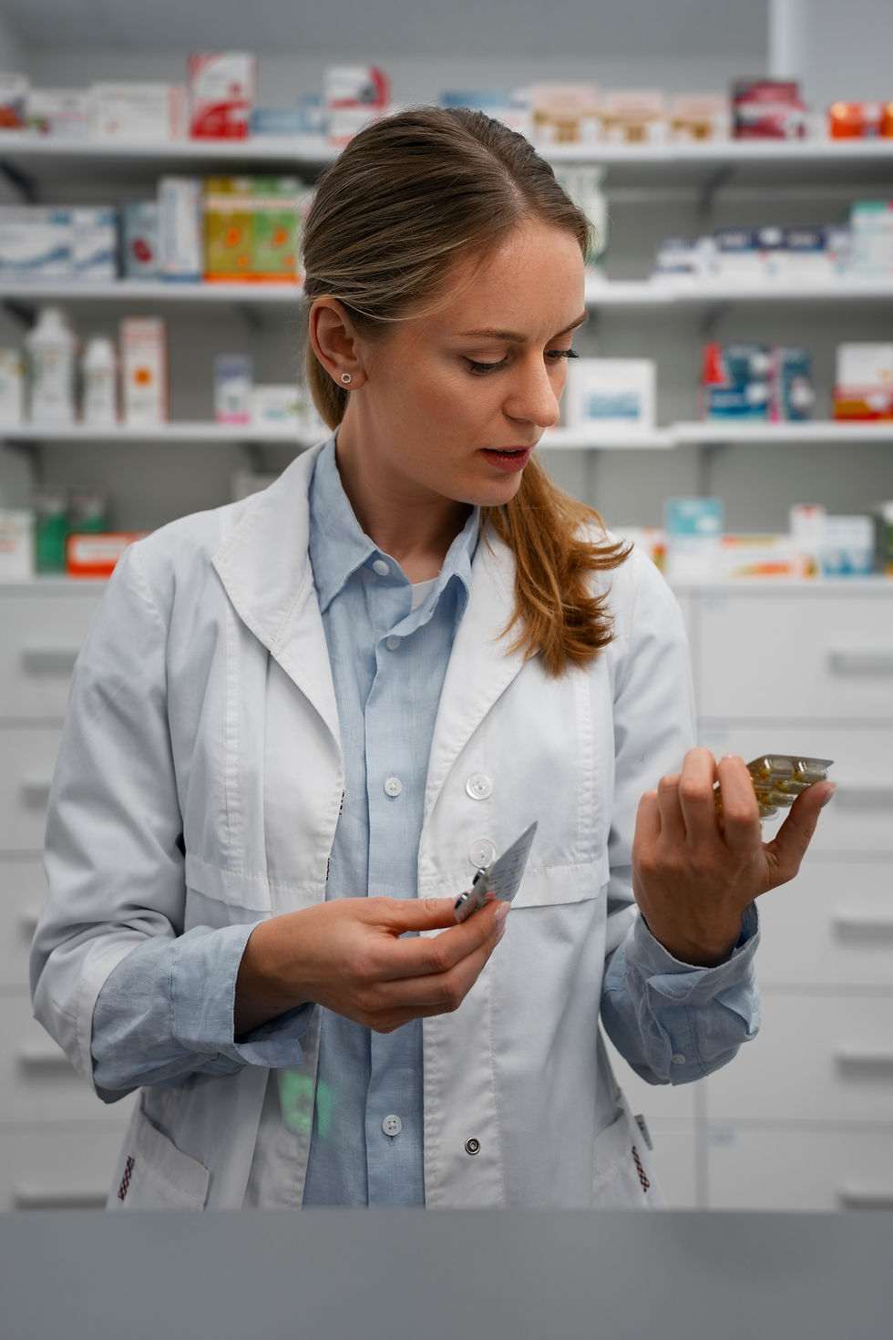 female-pharmacist-checking-pills-pharmacy.jpg