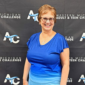 Sandy standing in front of ATC backdrop