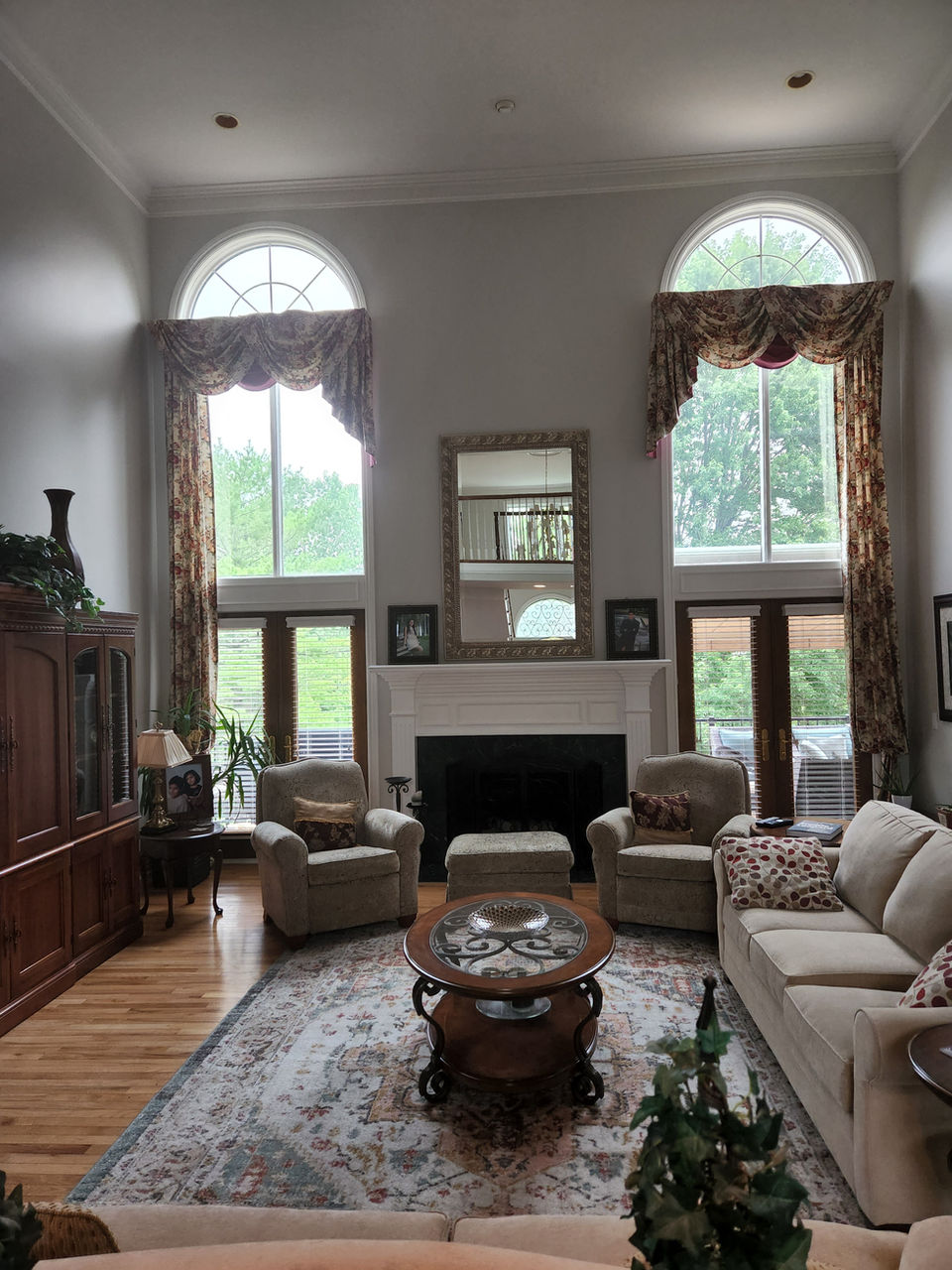 Renovated living room with high ceilings and windows