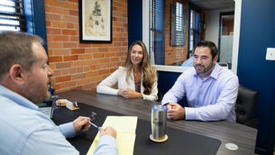 a lawyer meeting with two clients