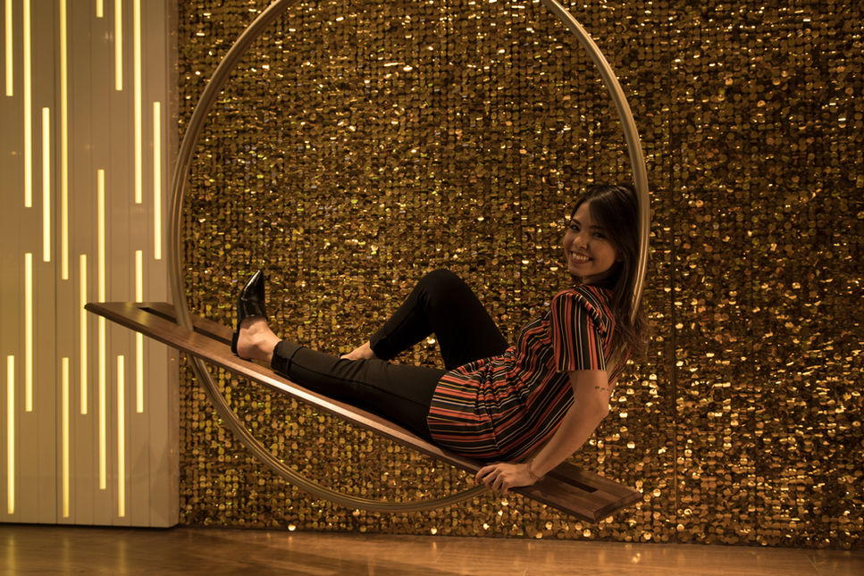 Woman lying back along the Horizon Swing seat, demonstrating one of the many possible seating positions