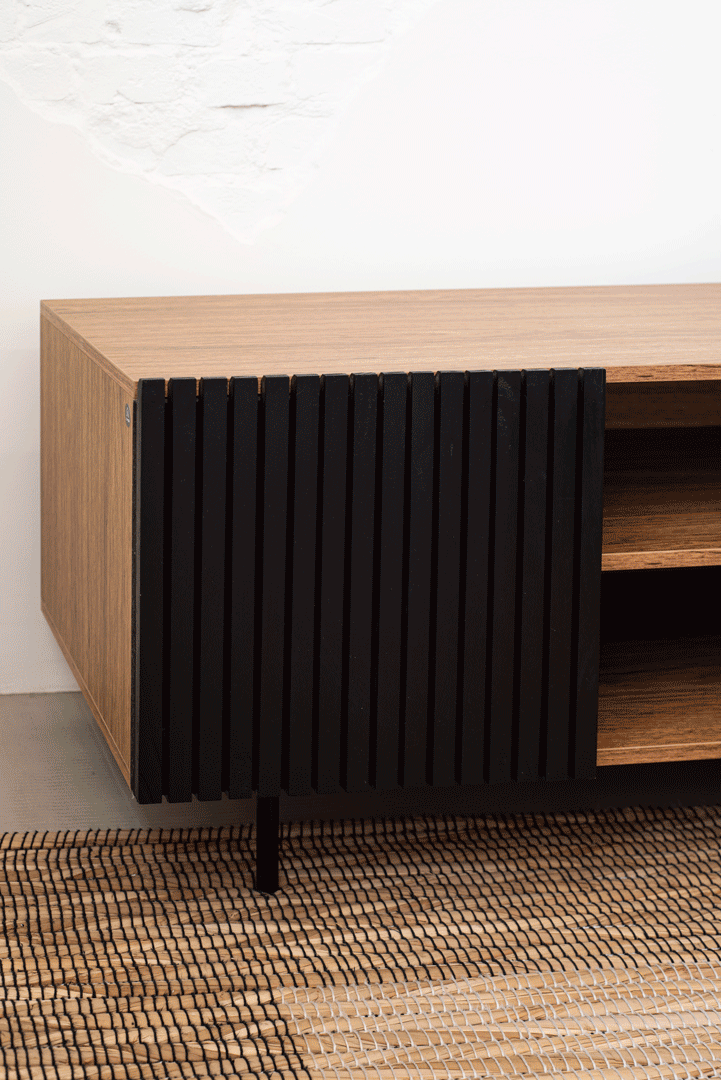 Animation of the Zero Media Console's black slatted door opening and closing over the wooden storage bay