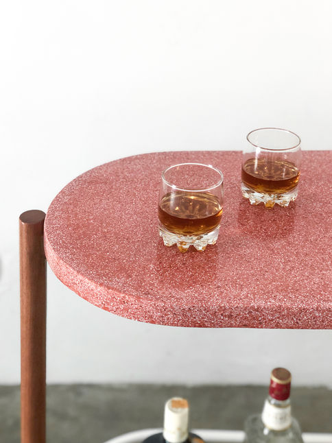 Close-up of the rounded pink terrazzo top of the Napoli Sideboard with two whisky glasses on it