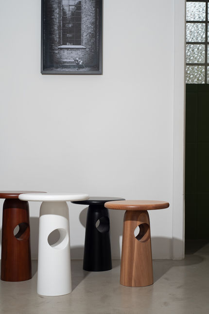 Four Singular Side Tables grouped together in dark red, white, black and natural wood