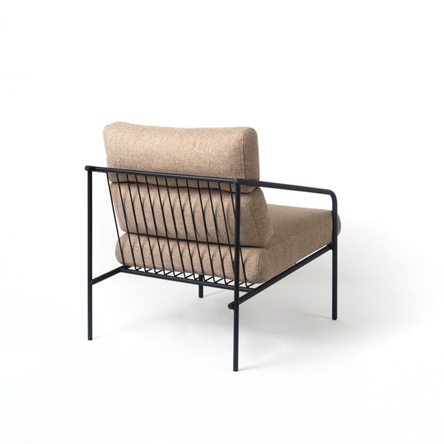 Back view of the sand coloured Olavo Lounge Chair on white, showing the row of steel rods