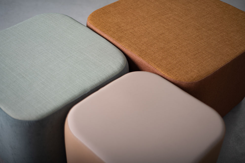 Overhead view of three Composé Ottomans, comparing the woven texture of the mustard and pale green tops with the smooth blush one